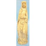 A 9 1/8" late 18th Century carved ivory figure of a nun wearing wimple and gown and holding a book