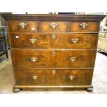 A 3' 3" antique cross banded and book matched veneered chest, with three frieze drawers and three