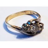 An 18ct. gold three stone diamond crossover ring