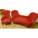 A Victorian walnut framed double chair back chaise longue with red velour button back upholstery -