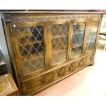 A 6' 10" antique style oak "Reprodux" cabinet by Bevan Funnell Ltd., with shelves enclosed by four