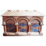 A 3' 9" ornate carved pine lift-top box in the form of a continental gatehouse, with triple arch