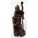 A carved hardwood Oriental figure of an Immortal and child