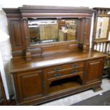 A 7' late Victorian oak sideboard with bevelled mirror set raised back, featuring dentil cornice,