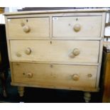 A 34" Victorian waxed pine chest of two short and two long graduated drawers, set on turned feet