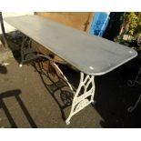 A 5' 10" zinc top table set on cast iron base, with pierced Winselmann Titan (sewing machine)