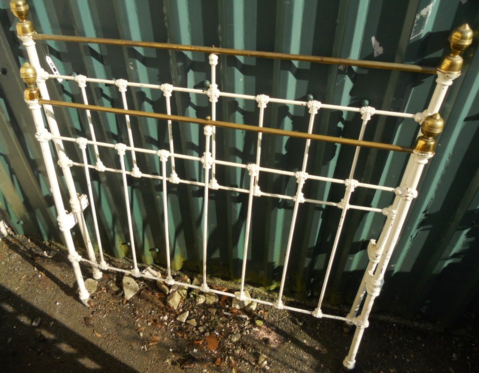 A 4' Victorian painted cast iron and brass bedstead