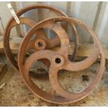 A pair of antique cast iron feed trough wheels