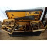 An antique carpenter's chest with fitted trays, containing a collection of good quality tools,