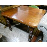 An Edwardian walnut extending dining table with canted corners, single leaf and winder, set on