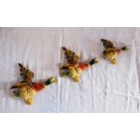 A set of three mid 20th Century painted cast metal graduated flying ducks - makers name Parkside and