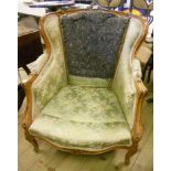 A French stained wood framed ornate boudoir armchair, with frosted green upholstery, set on carved