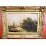 A 19th Century ornate gilt gesso framed oil on canvas depicting a Dutch waterway, with fisherman