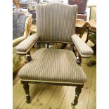 A late Victorian mahogany framed elbow chair, with striped upholstery, set on turned front legs