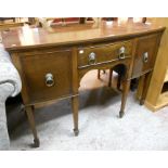 A 4' 6" 19th Century Georgian style mahogany bow front knee-hole sideboard, with central frieze