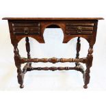 A 32 1/2" Georgian oak writing desk with flanking short drawers and turned supports, set on an