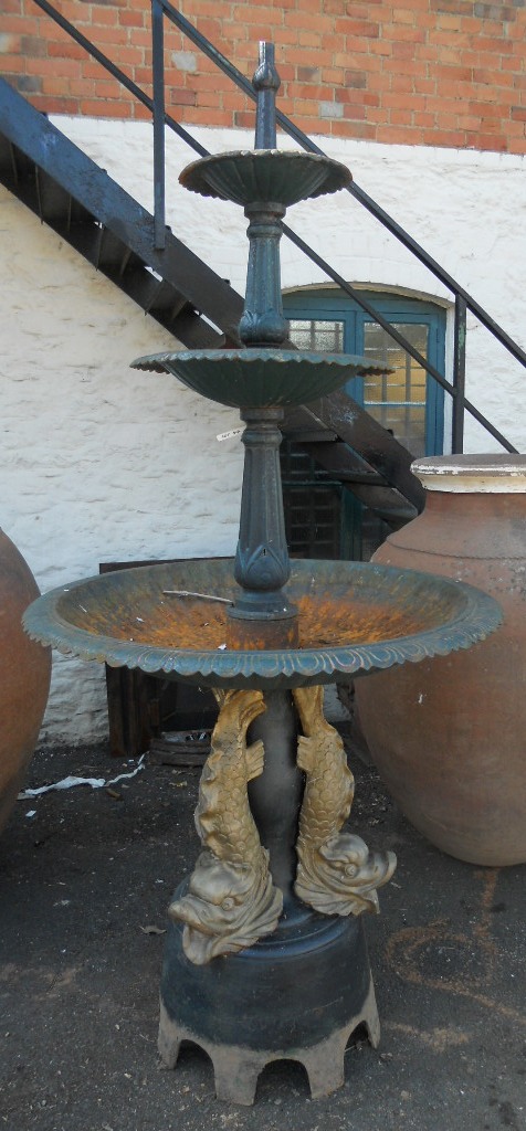 An 8' high cast iron three tier fountain with egg and dart decoration to rims, set on a pedestal