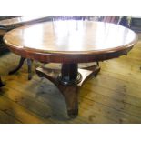 A 4' diameter 19th Century mahogany breakfast table, set on a faceted tapered pillar and trefoil