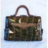 An Art Deco handbag made in absinthe green crocodile skin, with white metal frame, braided handle