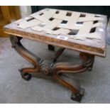 An early Victorian mahogany X-framed stool, with flowerhead bosses and acanthus scroll terminals -