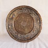 A Middle Eastern pierced copper plate with crescent moon and floral decoration