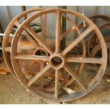 A pair of antique cast iron feed trough wheels