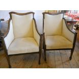 A pair of Edwardian strung box framed armchairs, with cream tapestry upholstery, set on square