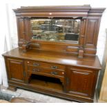 A 7' late Victorian oak sideboard with bevelled mirror set raised back, featuring dentil cornice,