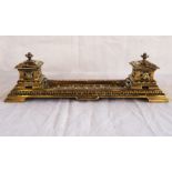 A pierced brass inkstand, with two inkwells and pen tray