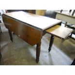 A Victorian oak drop-leaf extending dining table with patent stowed leaf action, set on turned legs