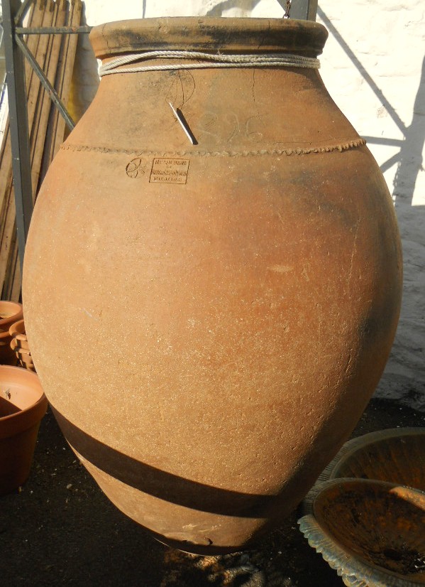 A 4' 11" high Spanish terracotta olive oil jar, stamped Francisco Chamizo Peguero, Majadas - 1896