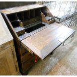 A 26 3/4" antique oak bureau with well fitted interior, two short and two long graduated drawers