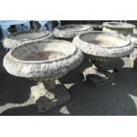 A set of four 15" high reconstituted concrete pedestal planters with egg and dart decoration to