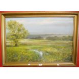 Peter J Carter: a gilt framed oil on board, depicting an extensive rural landscape - 22 3/4" x 35"