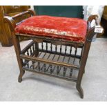 An Edwardian stained beech framed adjustable piano stool with upholstered seat, scroll ends,