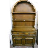 A 36" Old Charm polished oak Dutch style dresser, with dome top two shelf open plate rack, over a