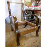 A heavy mahogany armchair frame with open arm rests and sabre front legs - for upholstering