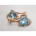 A pair of Russian 14ct. gold ear-rings, set with large central topaz and diamond bands