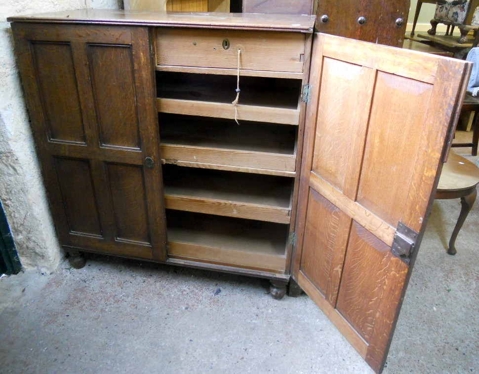 A 3' 6" Victorian oak linen press with two short drawers and four slides enclosed by a pair of