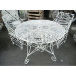 A 3' 4" diameter painted wirework garden table with extensive scroll decoration - sold with a pair