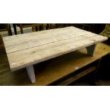 A reclaimed timber low coffee table, with rustic triple plank top