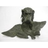 A cast metal inkwell in the form of a retriever's head holding a dead duck as a pen tray