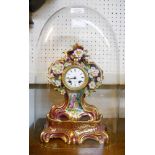 An early 19th Century porcelain cased mantel clock with floral encrusted decoration and painted