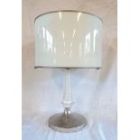 A cut glass column table lamp with lattice decoration and retro plastic shade, set on chromed base