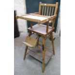 A 20th Century child's polished wood metamorphic highchair/play table, with folding action and