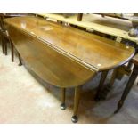 A 6' 19th Century oak slender oval gateleg dining table, set on tapered legs with pad feet