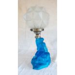 A 1930's opaque blue glass table lamp base in the form of a seated lady, with opaque polygonal