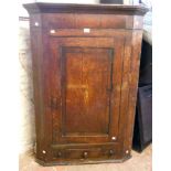 A 33½" Georgian oak and cross banded wall hanging corner cupboard, with central shell motif and