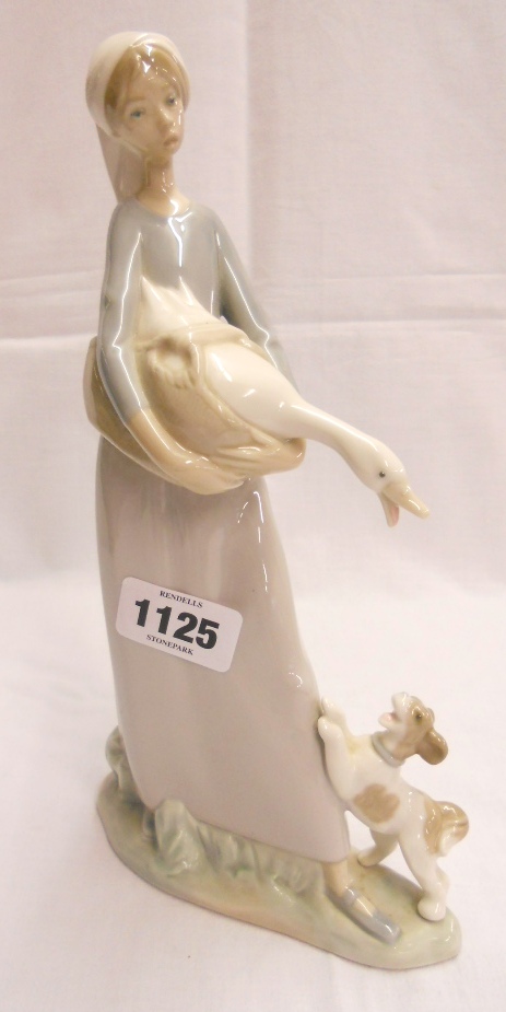 A 10¾" Lladro figure of a girl holding a goose with a small dog at her feet