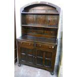 A 3' 5" 20th Century stained oak dome top two part dresser, with two short drawers and pair of